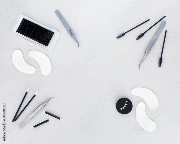 Fototapeta Eyelash extension treatment tools, products and equipment with space on the plain white background