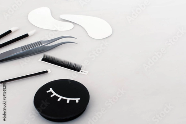 Fototapeta Eyelash extension treatment tools, products and equipment with space on the plain white background
