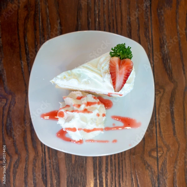 Obraz Strawberry crape cake top view on wooden