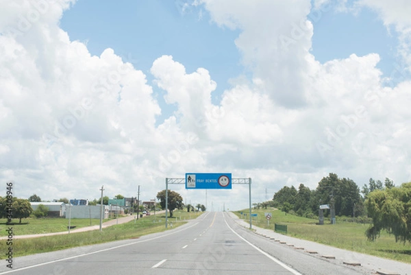 Obraz Road with the entrance sign to Fray Bentos, in the Oriental Republic of Uruguay