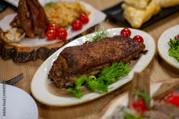 Fototapeta 
meat with greens and tomatoes on a plate