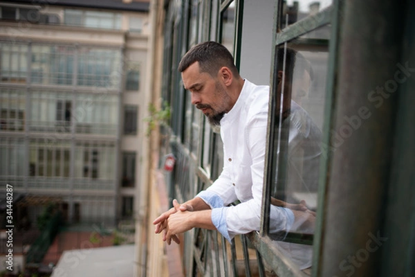 Fototapeta a young stylish man in an apartment in self-isolation