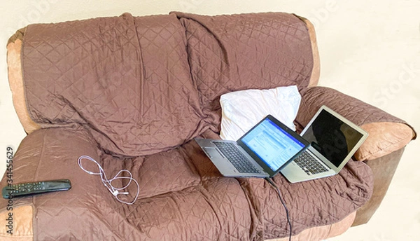 Fototapeta Work from home couch with laptops