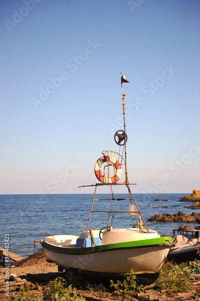 Obraz A small lifeboat on the beach.