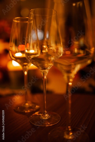 Fototapeta empty wine glasses with a blurred background. Warm color
