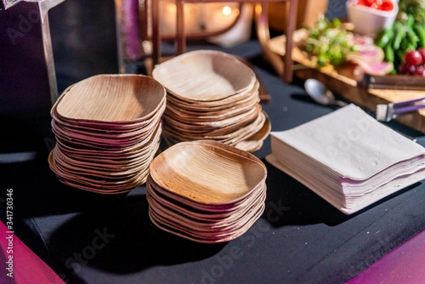 Fototapeta Eco environmentally friendly palm leaf plates from natural sustainable leaves.