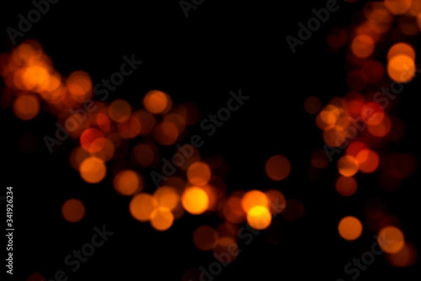 Obraz Shiny orange bokeh on a black background
