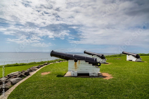 Fototapeta Kiama in Victoria, Australia - 13th February 2020: A german photographer visiting the Kiama Blow Hole landmark, taking pictures of the surroundings including historical canons.