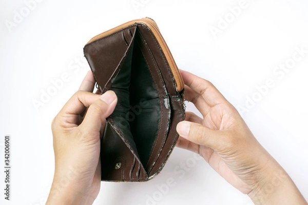 Fototapeta Lack of financial liquidity, Hand open an old empty wallet or purse on white background, no have money                                              
