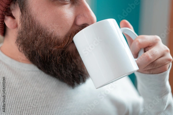 Obraz young designer with hipster style beard drinking coffee