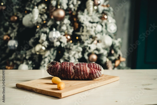 Fototapeta appetizing jerky on a festive table near the Christmas tree