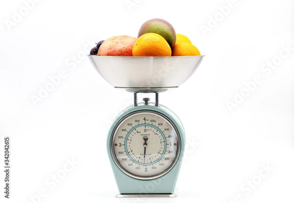 Fototapeta fruit on kitchen food scale on white background