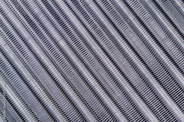 Fototapeta Tubes of cooling radiator as background. Top view. Bank of cells and aluminum tubes in which circulating fluid cooled by surrounding air.