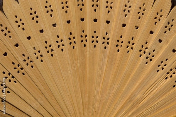 Fototapeta Folding wooden fan, disclosed. Light background, close-up. Asian traditions, china and japan. Wood and lace.