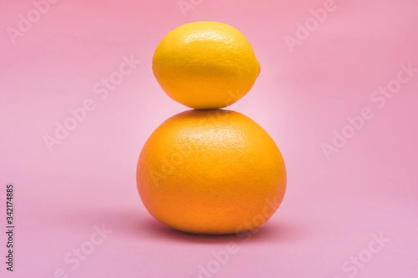 Obraz Fresh lemon, grapefruit, orange isolated on a pink background. Summer and seasonal fruits for a healthy lifestyle. Health care.