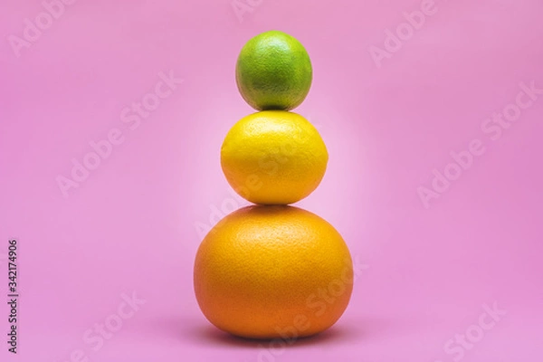 Obraz Fresh lime, lemon, grapefruit, orange isolated on a pink background. Summer and seasonal fruits for a healthy lifestyle. Health care.
