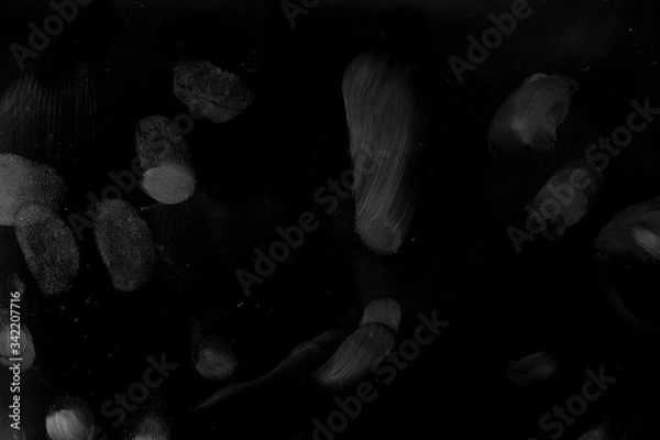 Obraz Finger Prints on solid black surface, macro shot