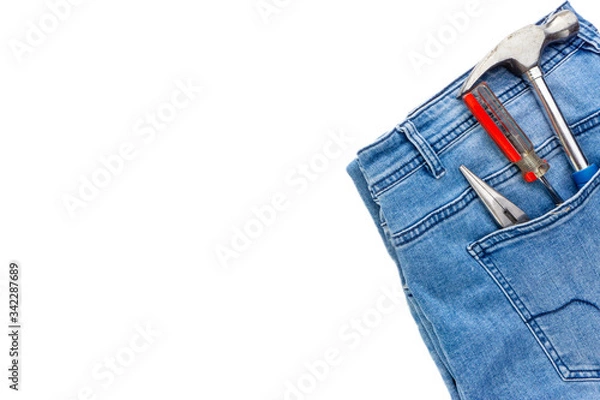 Obraz Jeans, screwdriver, hammer and pliers on white background. Jeans texture, Blue denim jeans with tools. Copy space concept