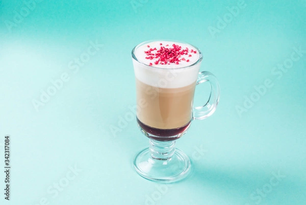 Fototapeta Latte with raspberry berry in a glass transparent glass with a handle
