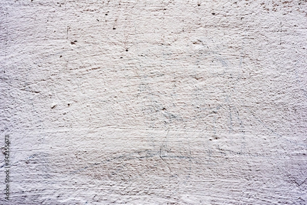 Fototapeta Texture of a concrete wall with cracks and scratches which can be used as a background