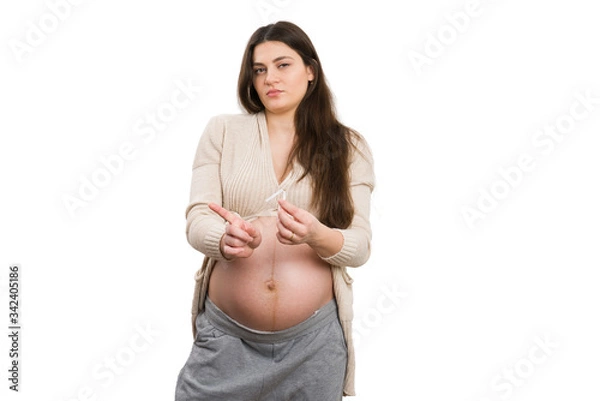 Fototapeta Future mother making not allowed gesture while holding cigarette