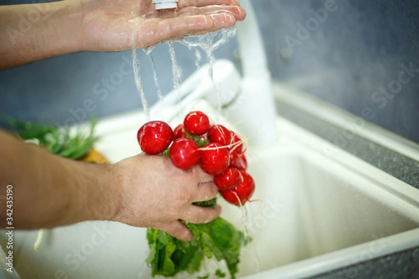 Obraz washing vegetables in the kitchen