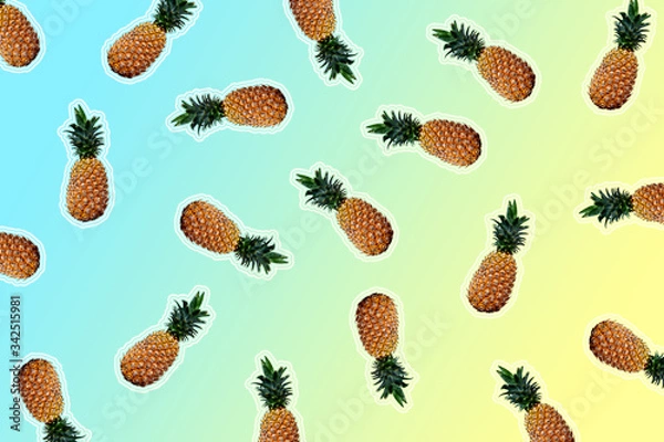 Fototapeta Ripe pineapples isolated on blue and yellow gradient surface. Exclusive ananas texture for summer background.