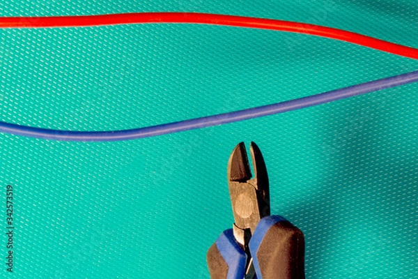 Fototapeta Cutting red or blue wire by wire cutters. Safety precautions, bomb neutralization
