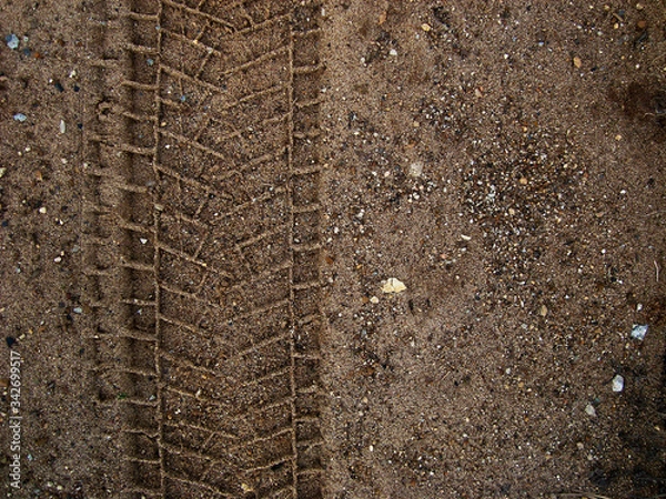 Fototapeta Tire tread mark on the ground. The concept of adventure and discovery, off-road driving.          