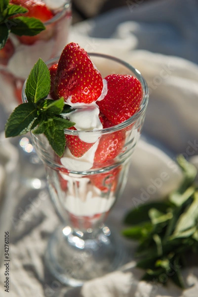 Fototapeta Fresh strawberries with yoghurt and whipped cream. Breakfast time. Healthy food. Delicious dessert sugar free. Vegetarian dish. Spring time 