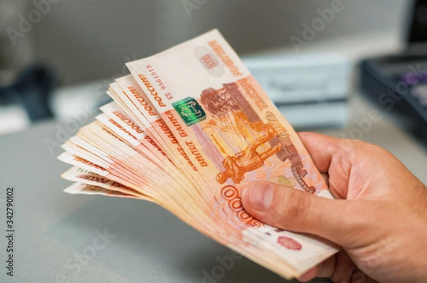 Obraz Russian rubles banknotes in a man's hand.