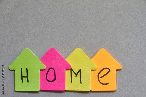 Fototapeta Word Home close-up made up of colorful paper houses with letters. Stay at Home picture. Coronavirus concept.