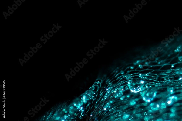 Fototapeta Background and backsplash of wet net with moist crystal water drops stuck between strings - abstract structure, technology, design, aquamarine gemstones