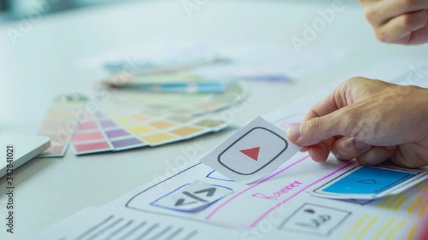 Fototapeta Designers man drawing (UX) (UI) Graphic designer creative sketch planning application process development prototype for application on smartphone. selective focus, copy space,