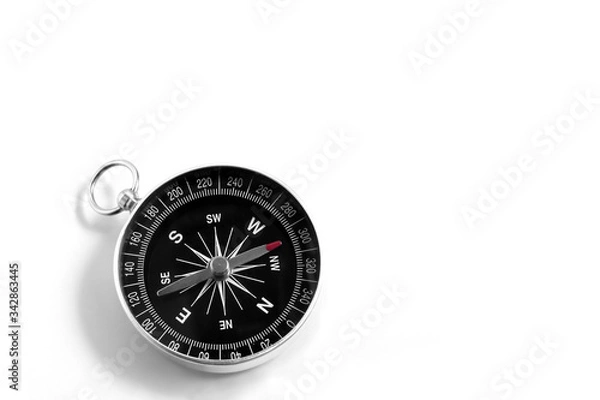 Fototapeta Closeup compass isolated on a white background. Travel geography navigation. Copy space