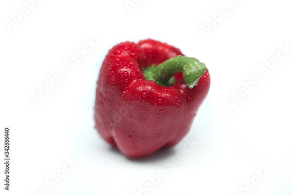 Obraz Close-up of fresh red bell pepper isolated on a gray background. Washed pepper with drops of water on the table. Healthy lifestyle. Seasonal and summer vegetables