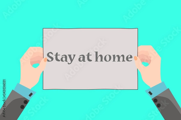 Obraz Two hands hold a placard that says Stay home.