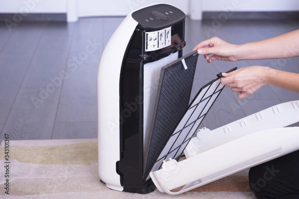 Fototapeta Changing or cleaning the air purifier HEPA filter after using for a long time