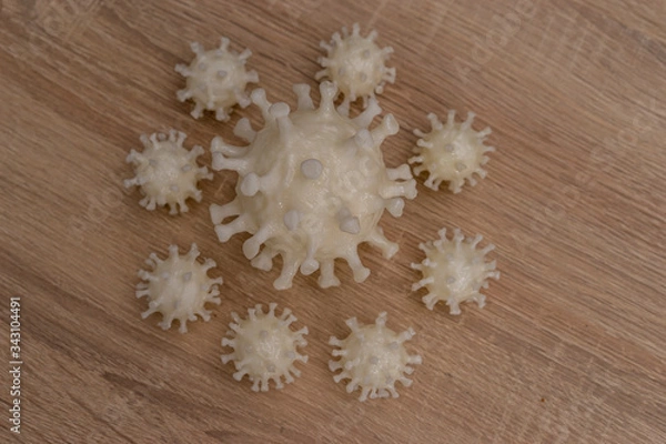 Fototapeta covid19, 3d printed representation of the virus on a wooden surface. home security and protection against viruses