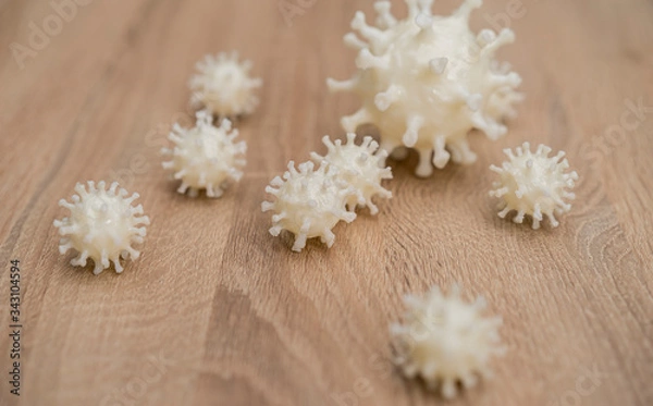 Fototapeta covid19, 3d printed representation of the virus on a wooden surface. home security and protection against viruses