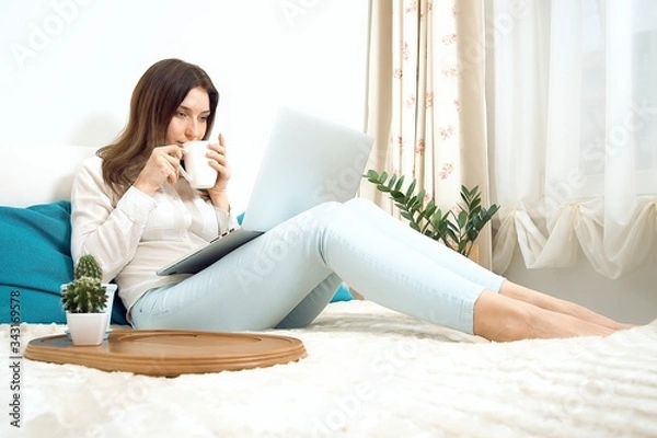 Obraz Work from home. Woman runs business from home. Remote work on the internet