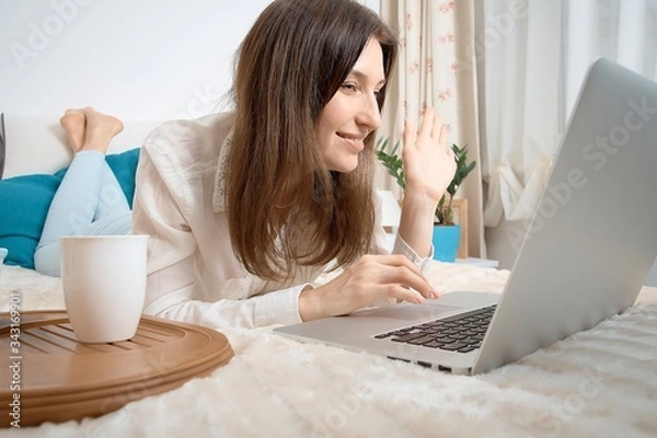 Obraz Work from home. Woman runs business from home. Remote work on the internet