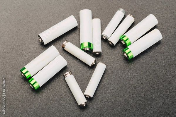 Fototapeta Close the positive poles of the used battery on a black background.