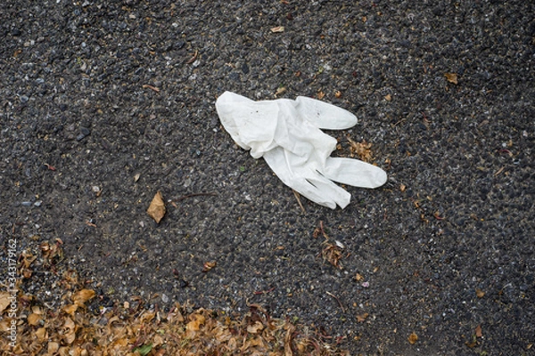 Obraz Closeup of used latex glove abandoned in the street