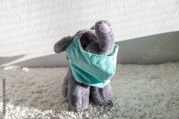 Obraz Plush elephant toy with the respirator mask on the table. Slovakia