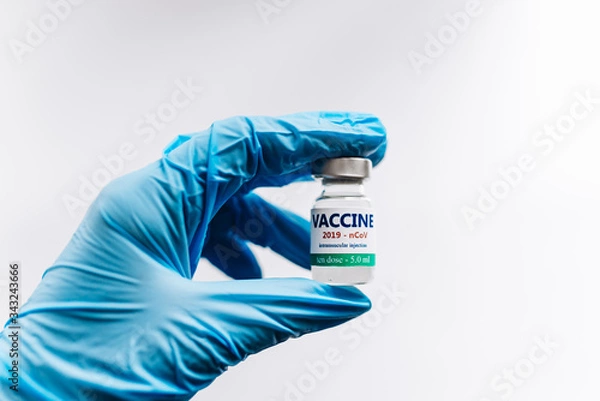 Fototapeta Coronavirus vaccine in his hand, Vaccine and syringe injection It use for prevention.