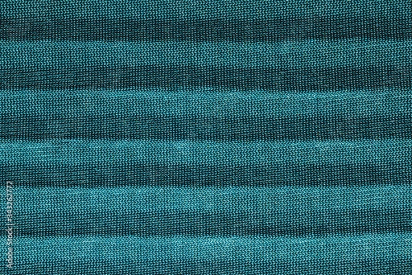 Fototapeta Green textile with parallel folds. fabric texture with flat creases. cloth background