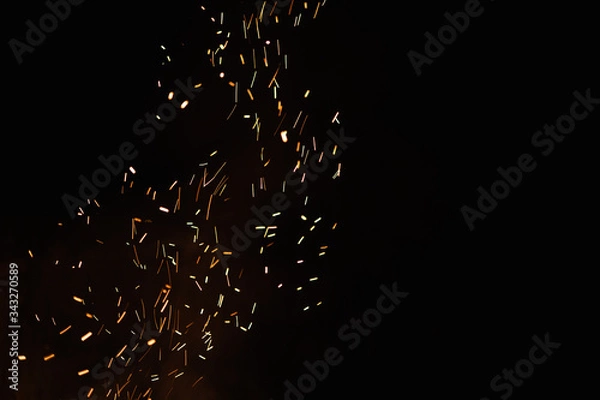 Obraz Group of flying sparks in the black background