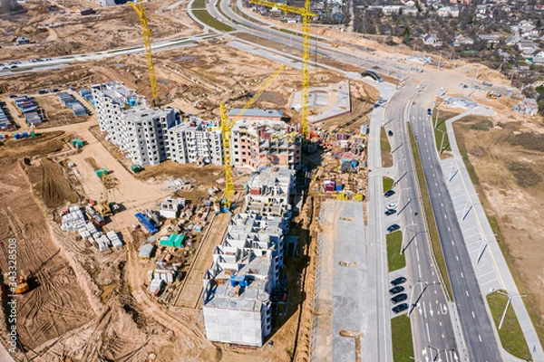 Fototapeta aerial topdown view of large construction site in city. new residential district under construction
