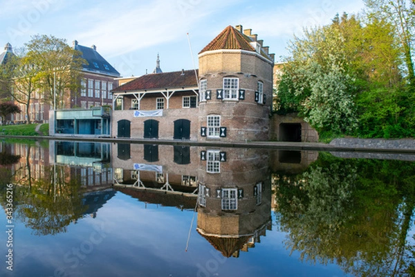 Fototapeta Canal view of a beautiful historical building/architecture in Delft.